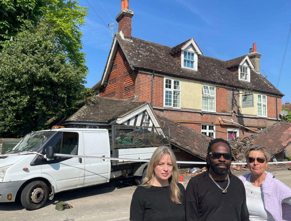 Clouncillor, Joa Saunders, Landlord, Fitzroy Benjamin, and Councillor Lucy Agace outside the Blacksmiths Arms after van crashes in to and gets lodged in pub front.
